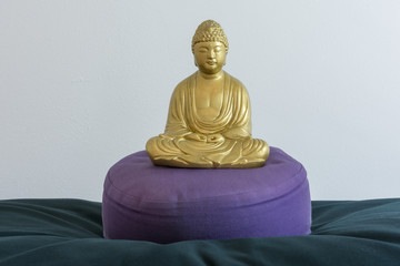 Buddha statue on meditation pillow