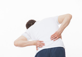 Young man demonstrating a pain in the small of the back