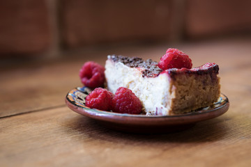 a piece of cheesecake with raspberries 