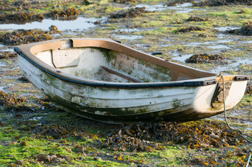 Fishing boat at sunrise at low tide in the estuary