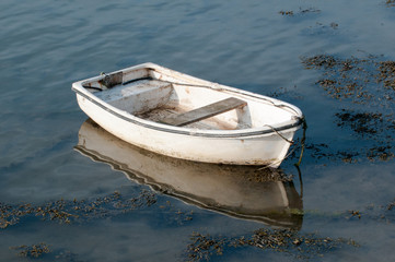 Small fishing boat moored in the water ready for sailing