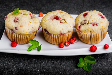 Homemade strawberry muffins in paper cupcake holder