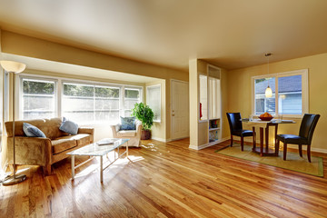 Open dining room with hardwood floor connected to dining room