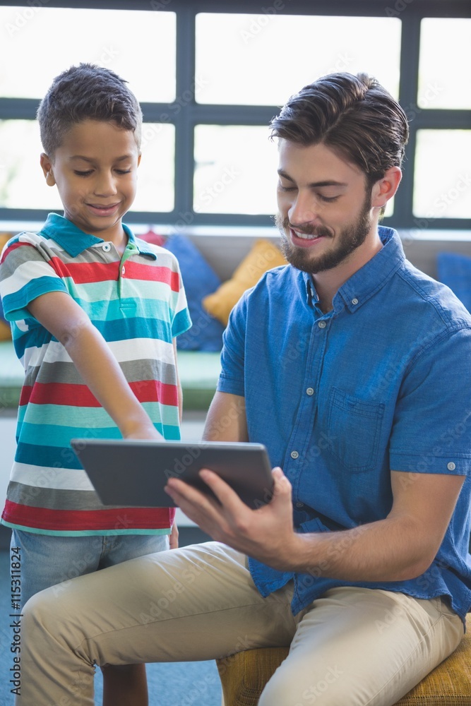 Poster teacher and school kid using digital table in library