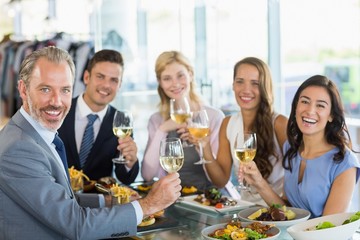 happy business colleagues toasting beer glasses