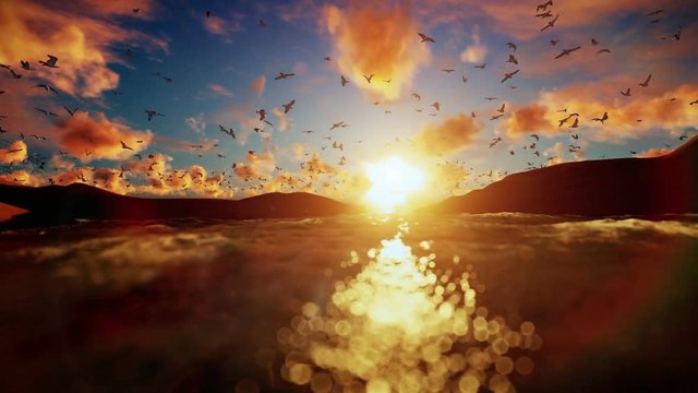 Lake surrounded by hills with seagulls flying against beautiful sunrise