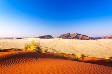 Detail of a red dune and mountains in Namibia, Africa