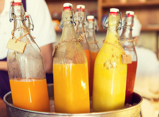 bottles of juice in ice bucket at market
