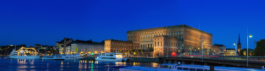 Royal palace in Stockholm illuminated at night - panoramic view