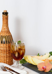 Slices cut melon and fruity cold drink