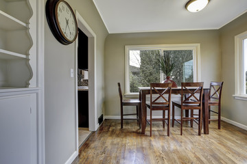 Large green dining room with wooden chairs