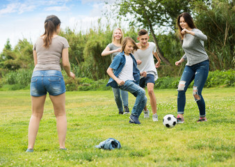 Teenagers friends running with ball