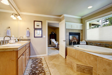 Classic American bathroom with wooden cabinets, two white sinks