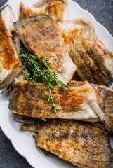 Fried fish with golden crust on a white plate