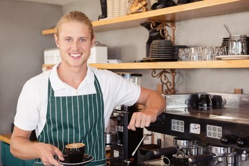 Waiter holding a cup of coffee