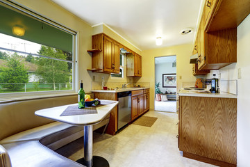Cozy dining area with corner sofa connected with kitchen room.