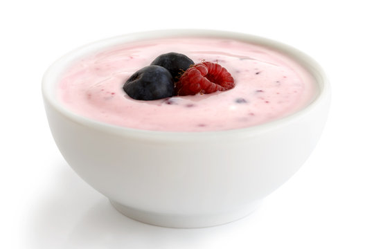 Ceramic bowl of fruit yoghurt with berries.