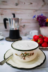 Breakfast served in a terrace - coffee, natural yogurt, strawber