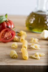 Variety of types and shapes of Italian pasta with tomato and deposit extra virgin olive oil