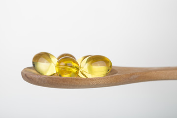 Omega 3 pills on a spoon.
