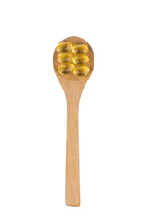 Omega 3 pills on a spoon.