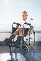 Fototapeta premium Portrait of schoolkid sitting on wheelchair