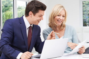 Mature Woman Meeting With Financial Advisor At Home