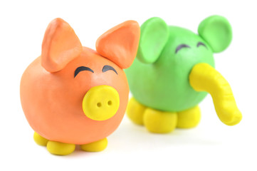 Plasticine pig and elephant on white background