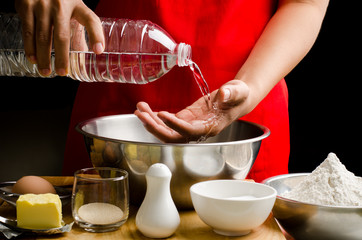 Preparation bread cooking,pouring the water in the the bowl