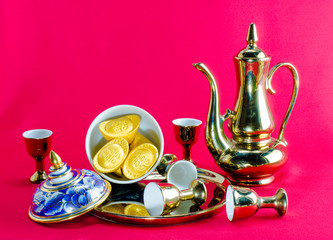 Gold ingot Gold jug Tea glass benjarong  on red background.