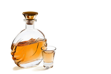 Bottle and shot glass tequila on white background