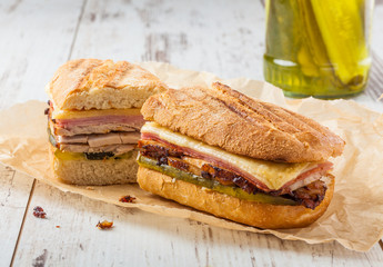 Cuban sandwich called Cubanito. Popular latin sandwich with marinated roasted pork, ham, cheese and...