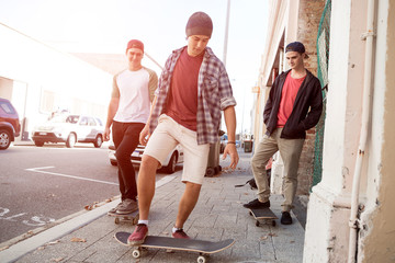 Guys skateboarders in street