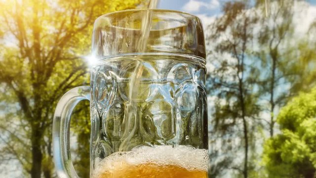Fresh bear pouring into glass at outdoor party. 4k