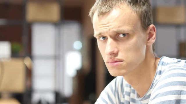 Closeup portrait of man tired, stressed, tense in Office