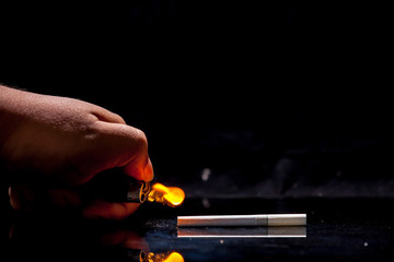 burning cigarette in hand