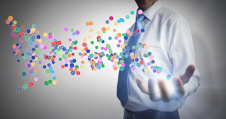 Composite image of businessman holding hand out