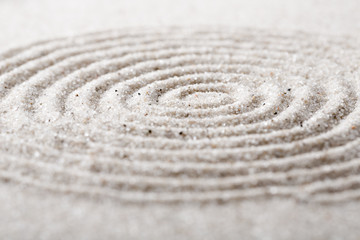 Obraz premium Japanese zen garden meditation stone for concentration and relaxation sand and rock for harmony and balance in pure simplicity - macro lens shot