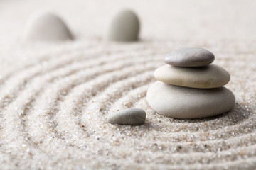 Obraz na płótnie Canvas Japanese zen garden meditation stone for concentration and relaxation sand and rock for harmony and balance in pure simplicity - macro lens shot