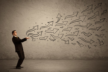 Business man holding arrow signs