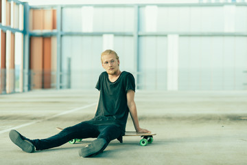 Portrait of Young Long Haired Man with Longboard
