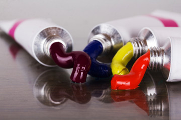 Open tubes with coloured paint coming out