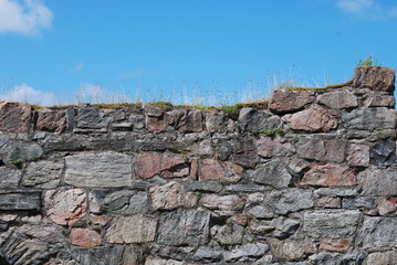 Stone wall and blue sky, background