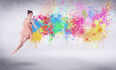 Naklejka na ściany i meble Modern street dancer jumping with colorful paint splashes
