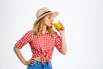 Portrait of beautiful country girl with juice over white background.