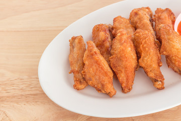 chicken wings on plate with sauce, carrots, and celery