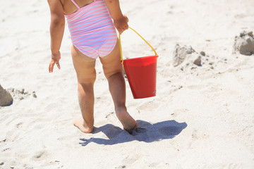 little girl play with sand on beach