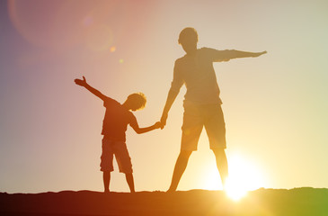 father and son having fun on sunset