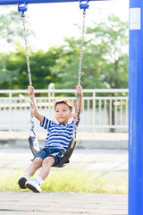 Asian boy play with swinging. with swinging.