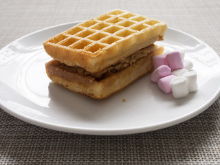 Waffles with peanut butter and marshmallows.